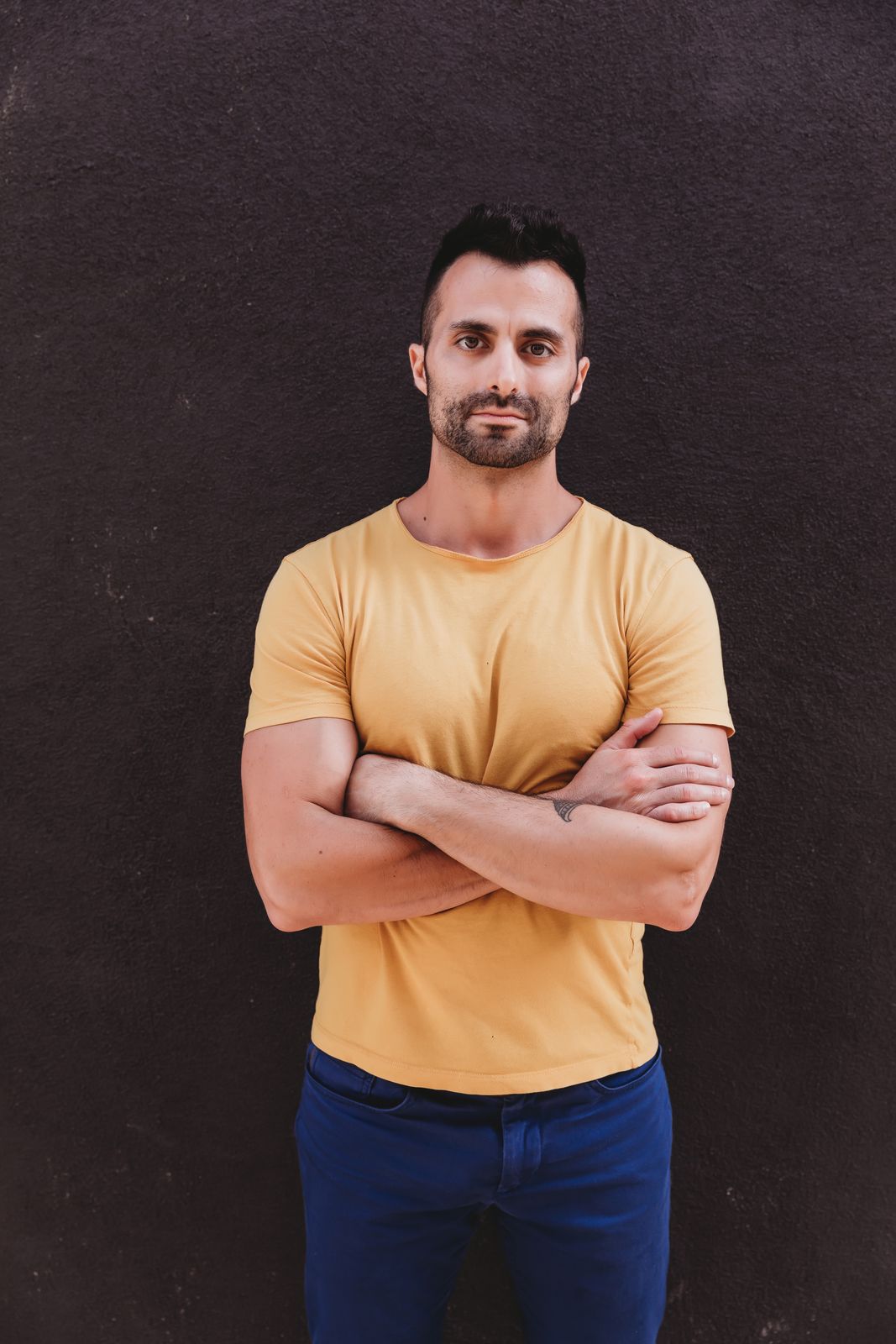 Guy Ferdman, arms crossed, in a yellow t-shirt